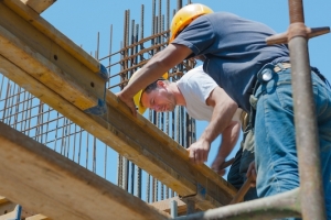 Construction workers placing formwork beams