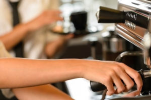 Close up hands waitress make coffee