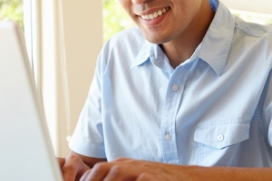 Filipino man working on laptop